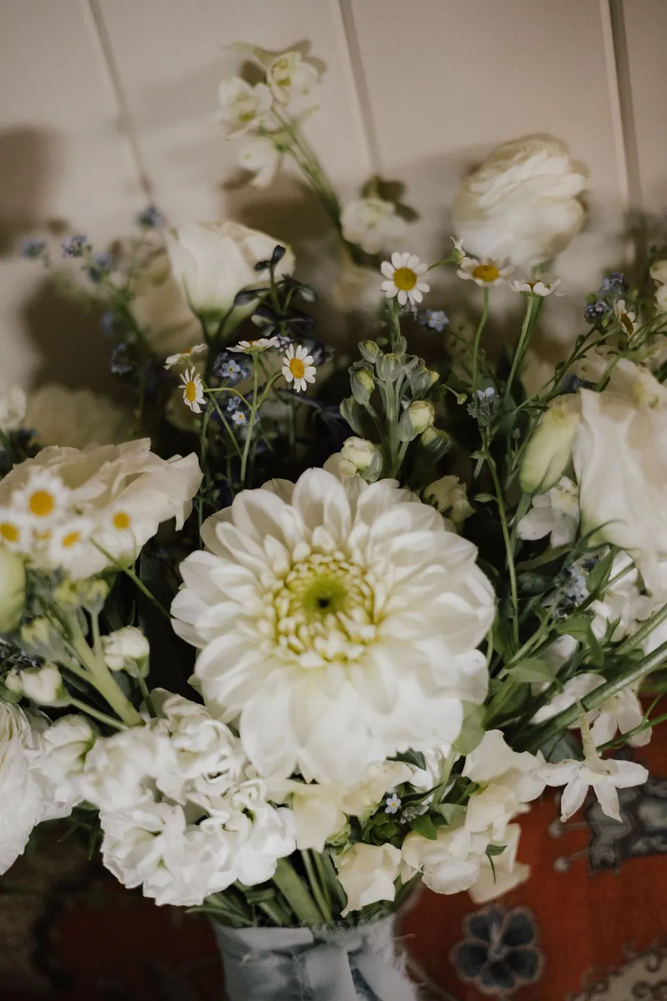 Close-up of white flowers and fresh foliage in Bridget's bouquet by Fifth Avenue Florist. At Cudgera Creek in northern New South Wales, for an Elopement Collective elopement. Photograph by Bulb Creative.
