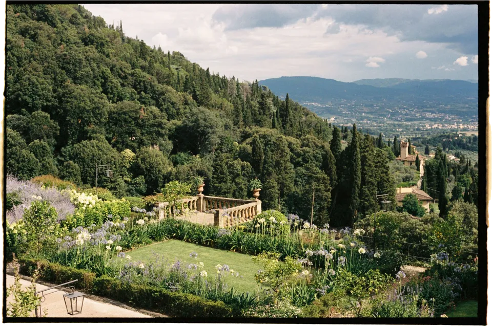 The villa’s garden, stone balustrade and view across Florence, at Villa San Michele in Fiesole above Florence, Tuscany, Italy, for an Elopement Collective elopement. Film photograph by Khara from House of Lucie.