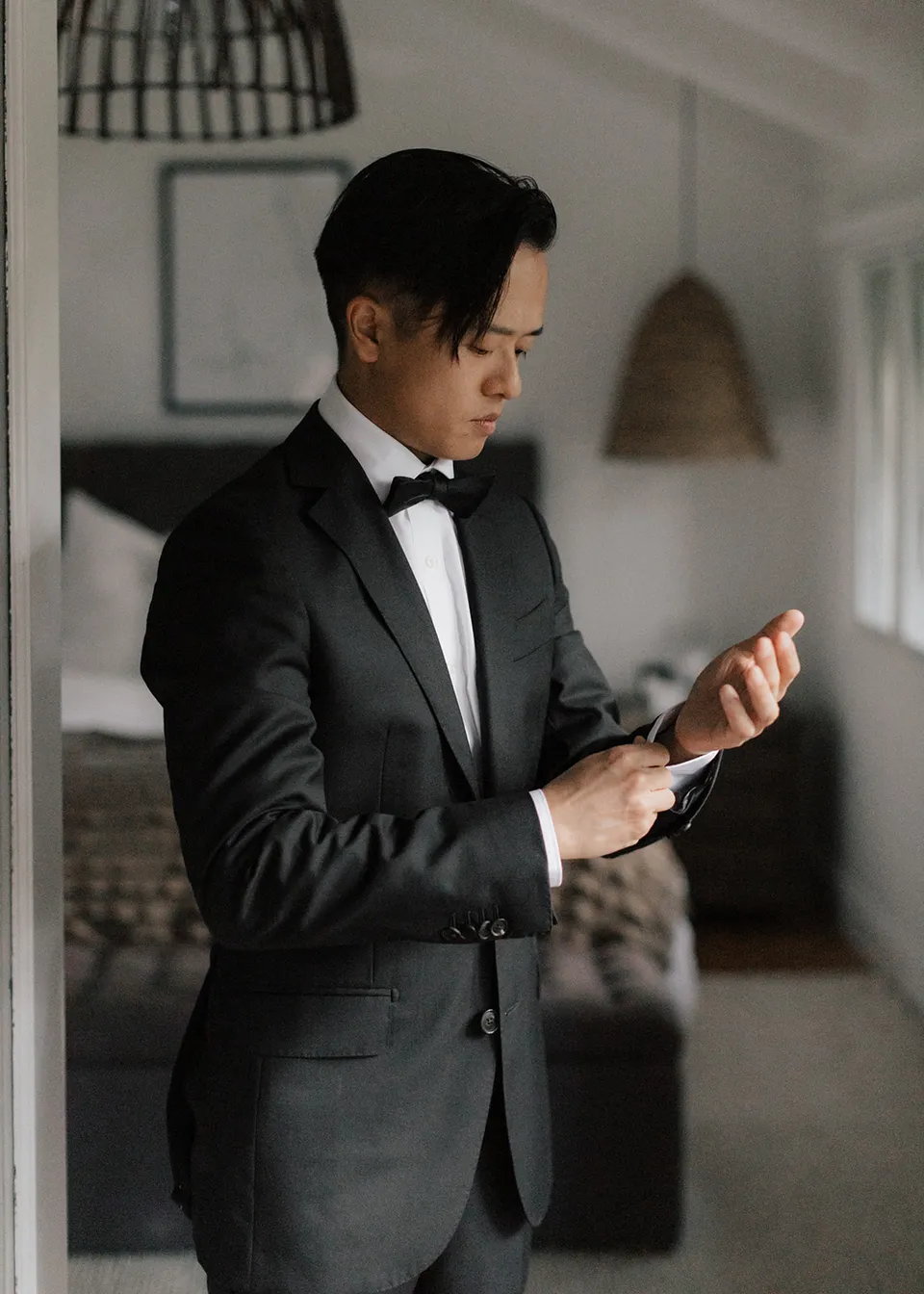 Jonathan adjusting his watch before the ceremony. At Fig Tree Villa in Ewingsdale, Byron Bay, for an Elopement Collective elopement. Photograph by Bulb Creative.