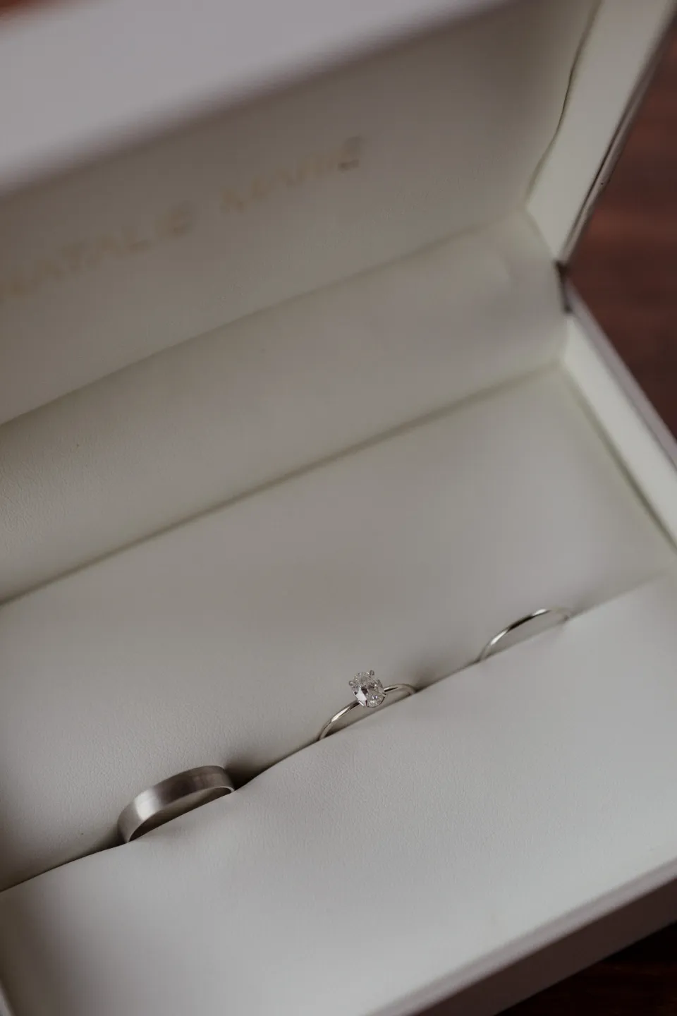 Wedding rings resting in an open presentation box, at Thalia Haven on the East Coast of Tasmania, Australia, for an Elopement Collective elopement. Photograph by Joey Willis.