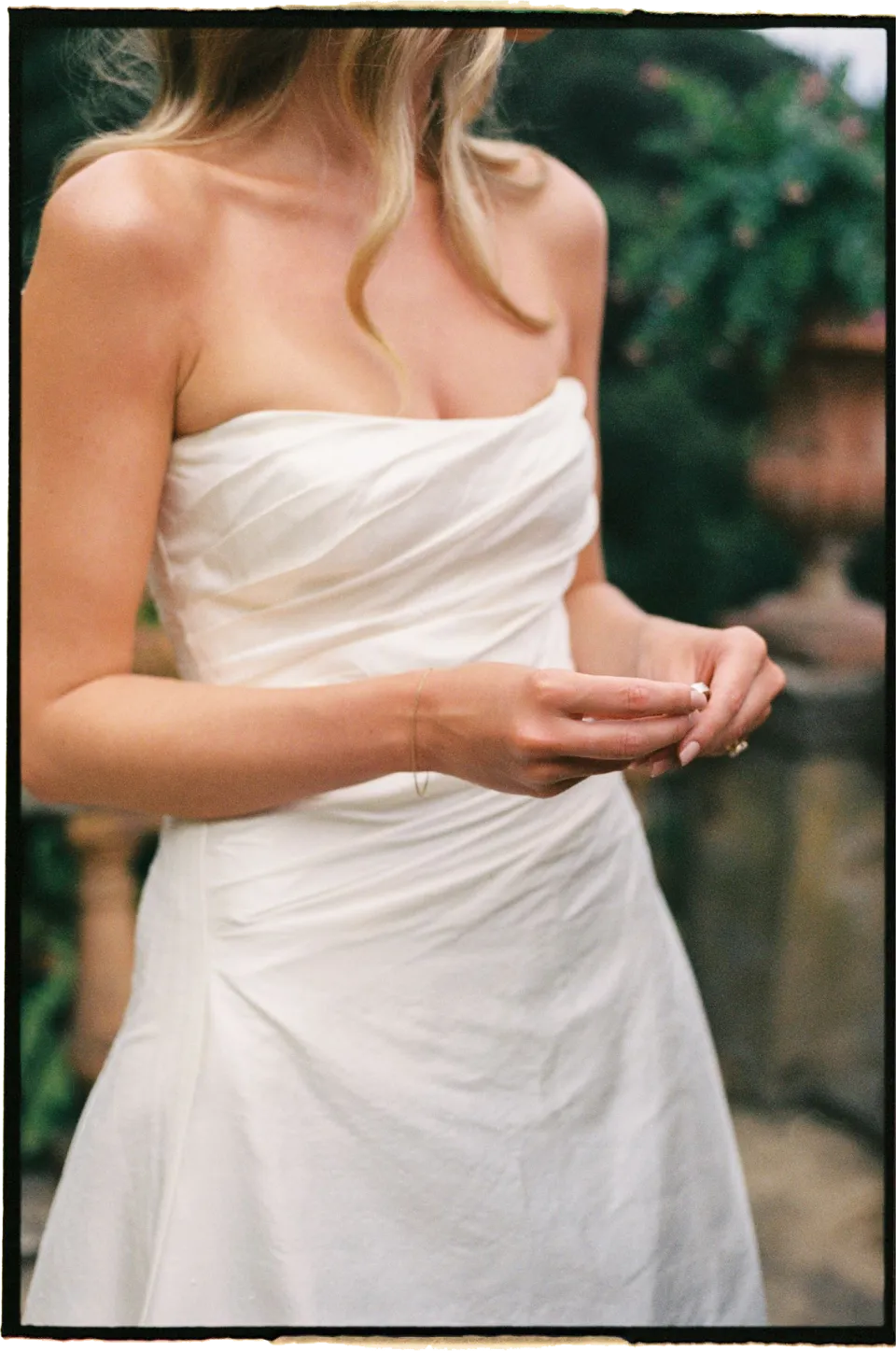 Close view of Holly’s hands and draped white wedding dress during the terrace ceremony, at Villa San Michele in Fiesole above Florence, Tuscany, Italy, for an Elopement Collective elopement. Film photograph by Khara from House of Lucie.