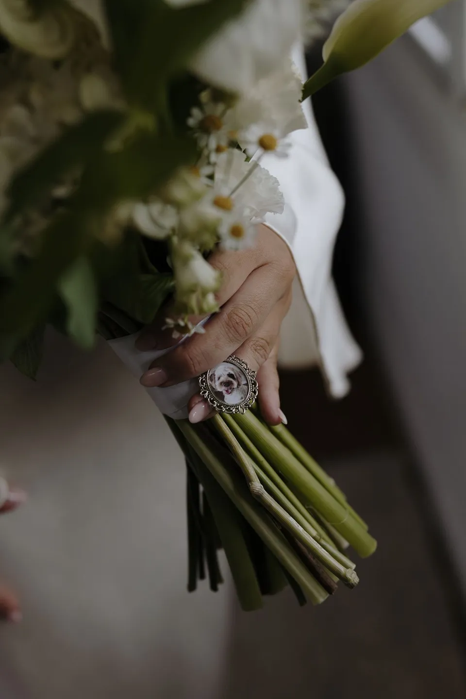 Close-up of Laura's hands and wedding rings around the bouquet stems. At Fig Tree Villa in Ewingsdale, Byron Bay, for an Elopement Collective elopement. Photograph by George Bowden.