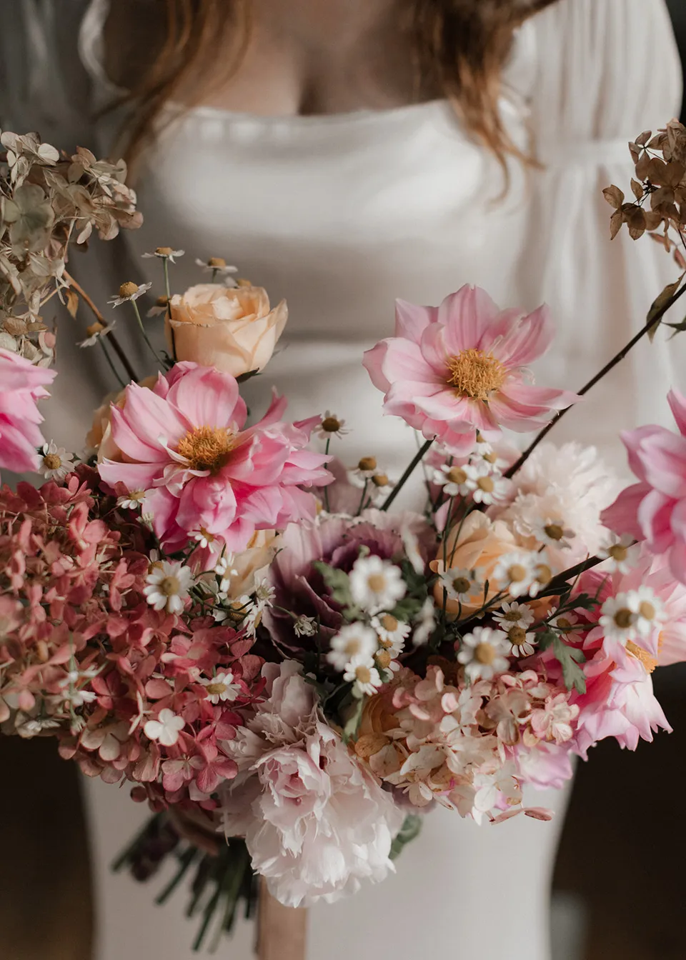 Close-up of Elyse's bouquet with pink flowers, cream blooms and delicate branching stems, with flowers by The Perfect Party Co. At Fig Tree Villa in Ewingsdale, Byron Bay, for an Elopement Collective elopement. Photograph by Bulb Creative.