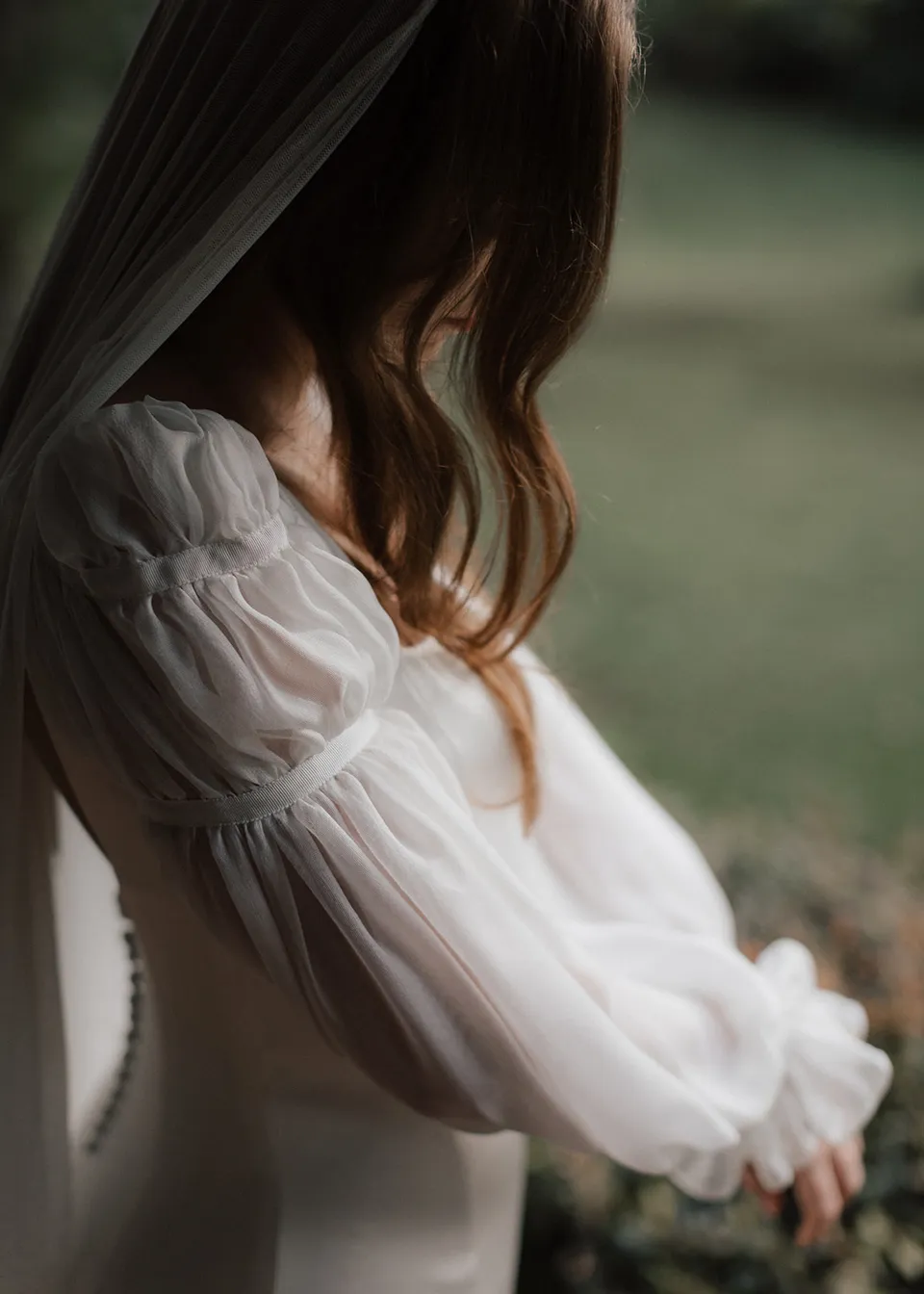 Close-up of the gathered fabric and sheer sleeves of Elyse's dress. At Fig Tree Villa in Ewingsdale, Byron Bay, for an Elopement Collective elopement. Photograph by Bulb Creative.