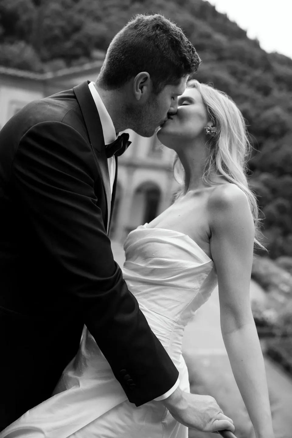Black-and-white close portrait of Holly and Matthew kissing in the garden, at Villa San Michele in Fiesole above Florence, Tuscany, Italy, for an Elopement Collective elopement. Digital photograph by Khara from House of Lucie.