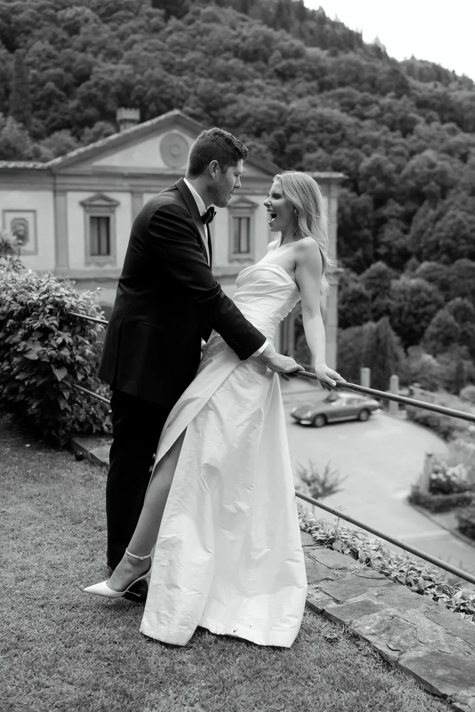 Black-and-white photograph of Holly and Matthew holding hands on the garden steps, at Villa San Michele in Fiesole above Florence, Tuscany, Italy, for an Elopement Collective elopement. Digital photograph by Khara from House of Lucie.