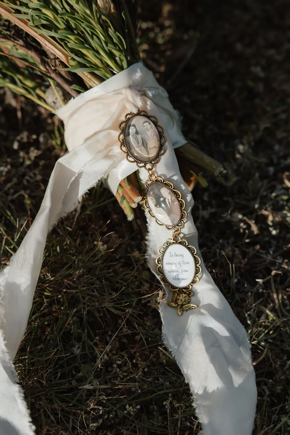 Small photograph charms attached to the ivory ribbon around Renee’s bouquet by The Romantics. At Piermont Retreat on Tasmania’s east coast, for an Elopement Collective elopement. Photograph by Bulb Creative.