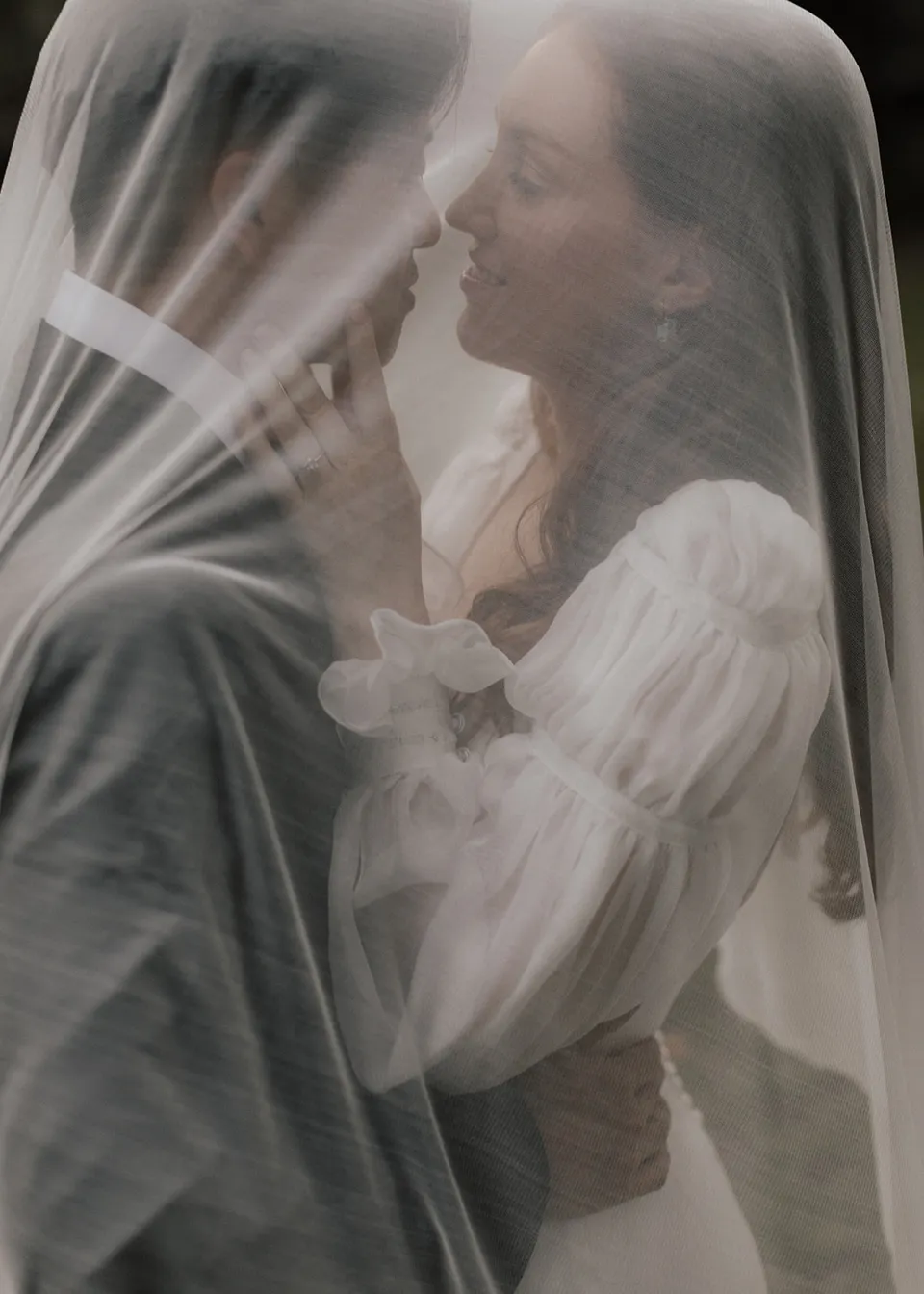 Elyse smiling at Jonathan beneath her sheer veil. At Fig Tree Villa in Ewingsdale, Byron Bay, for an Elopement Collective elopement. Photograph by Bulb Creative.