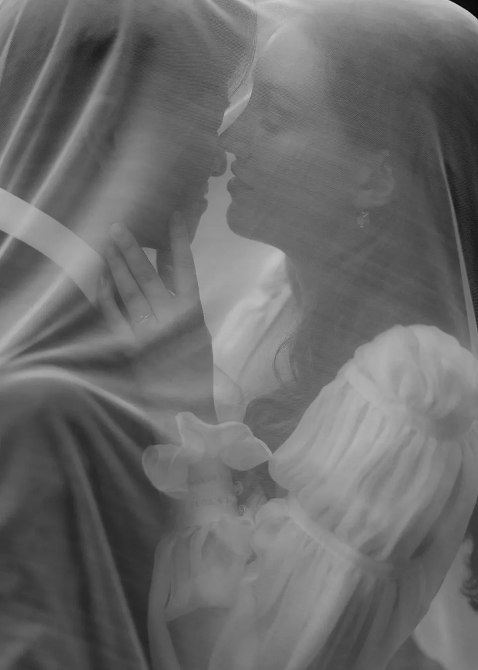 Soft close-up of the couple's faces seen through the veil. At Fig Tree Villa in Ewingsdale, Byron Bay, for an Elopement Collective elopement. Photograph by Bulb Creative.