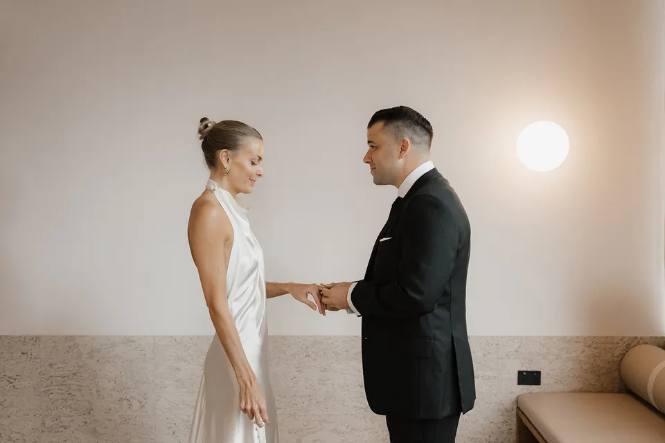 Clare and Matt holding hands during their indoor ceremony at The Calile Hotel in Fortitude Valley, Brisbane, with The Elopement Collective.