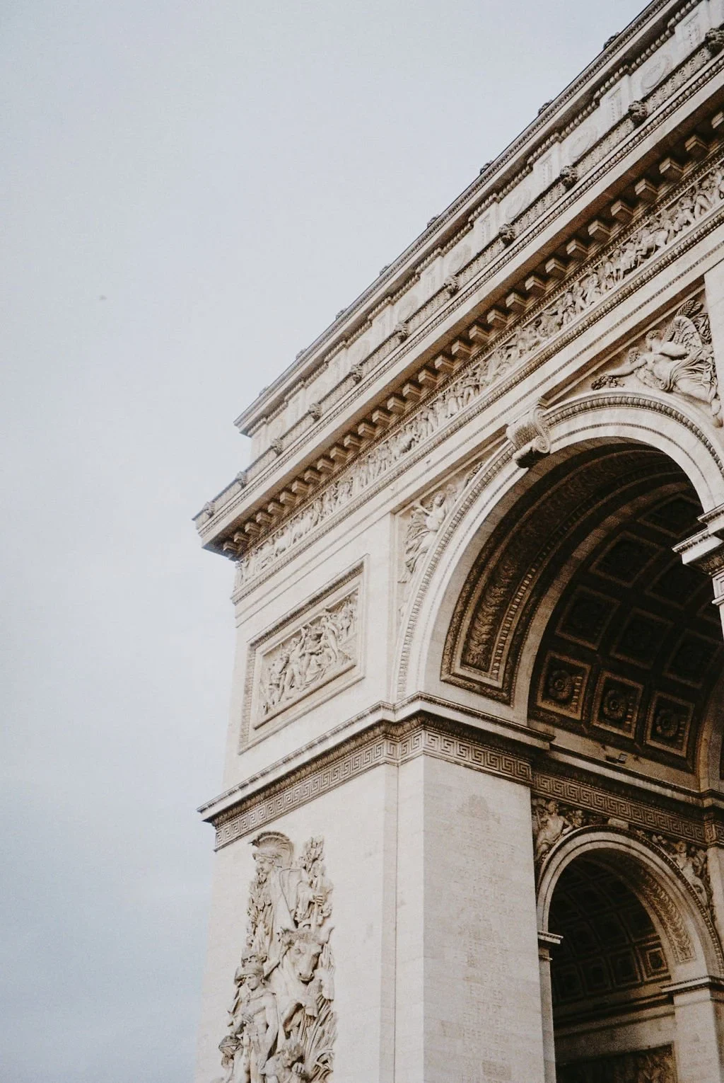 Top of Arc de Triomphe, Paris, with detailed sculptures and carvings.
